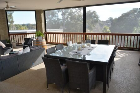 Complete outdoor area transformation by Livingston Outdoor Blinds using see through mesh blinds.